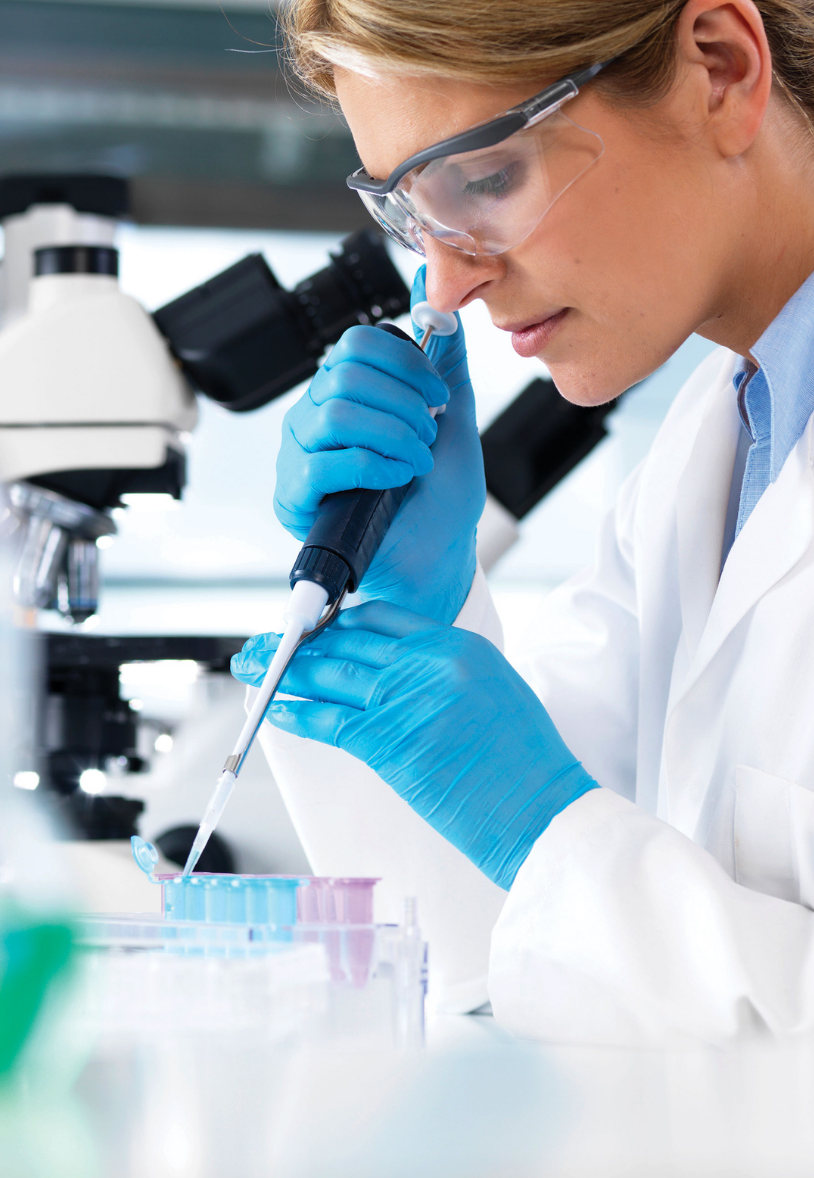female researcher pipetting in lab female researcher pipetting in lab